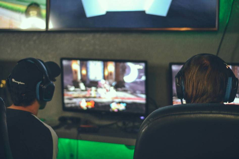 Diverse team of esports writers and analysts collaborating in a gaming-focused studio