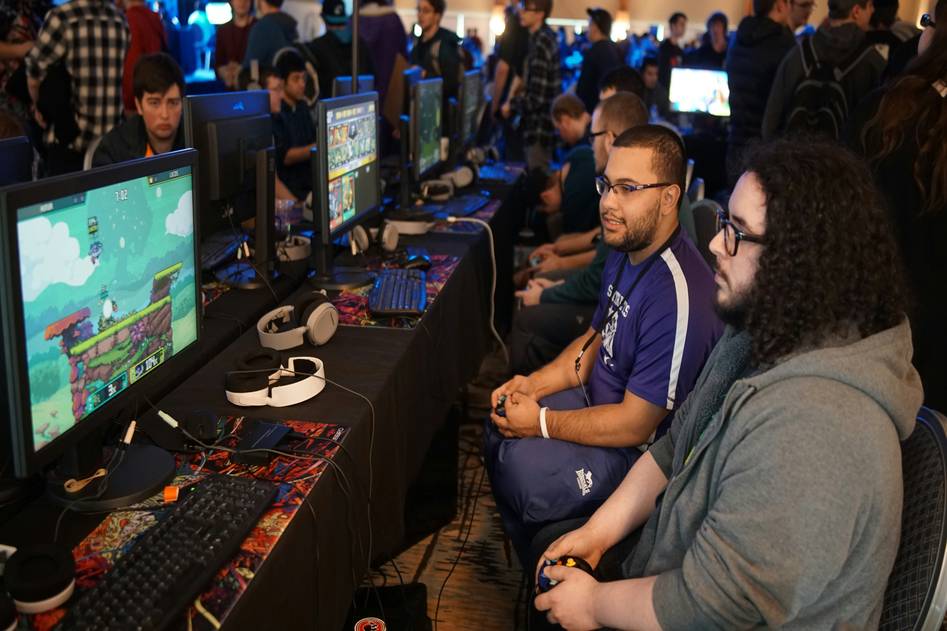 Fortnite World Cup stage with glowing arena, competitors in action, and digital scoreboard